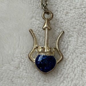 Blue gem necklace with crown and silver embellishment
